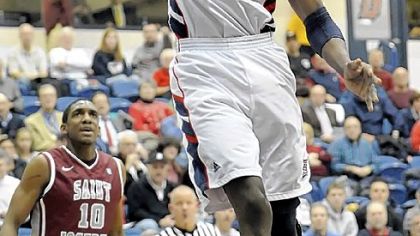 Duquesne's Mamadou Datt dunks against Saint Joseph's Wednesday at Palumbo Center.