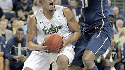 Dante Taylor defends against South Florida forward Ron Anderson Jr. in the first half Wednesday in Tampa, Fla. Pitt's winning streak ended with a 63-51 loss.