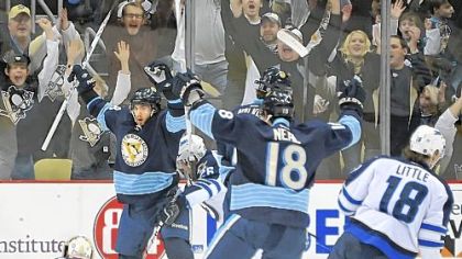 Kris Letang celebrates after scoring Saturday -- a recurring theme in the Penguins' 8-5 rout of Winnipeg at Consol Energy Center.