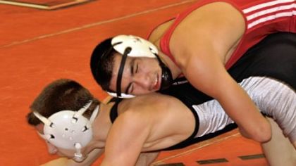 Drew Walker of North Hills, top, goes against Nate Hall of West Allegheny in the 126-pound semifinal match at the Allegheny County Wrestling Tournament this past weekend at Fox Chapel.