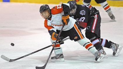Bethel Park's Zack Volzer and Upper St. Clair's Michael Sweeney battle for possession of the puck during the second period of the Black Hawks' 3-2 victory in a PIHL Class AAA game last week.