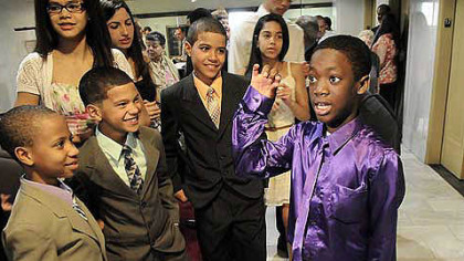 Fekens Dusch, 12, of Bon Air, shows his dance moves to the Owens brothers, from left, Kensly, 9, Gavin, 8 and Ayden, 11, after his adoption process at Allegheny County Orphans Court today.
