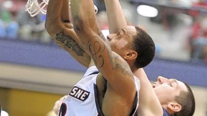 Andre Marhold of Duquesne muscles up a shot against La Salle's Steve Zack.