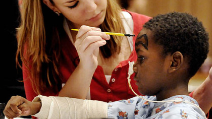 Mercy nursing student Stephanie Gibson paints the face of burn patient JaQuan Manus, 5, during the 18th annual Burn Survivor Sunday at UPMC Mercy. This year's reunion brought together 150 burn patients, their families and medical staff.