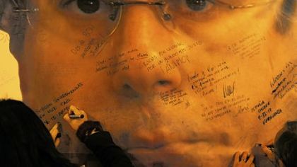 People sign a giant banner displaying a picture of Spain's Baltasar Garzon at Puerta del Sol square in Madrid during a demonstration Thursday in support of the former judge, hours after the Supreme Court convicted him in an illegal wiretapping case.