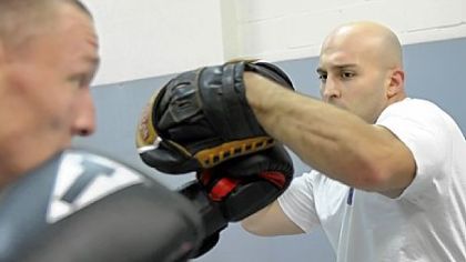 Chris Murawski, 24, of Murrysville, left, warms up with Mike Hampton, 27, of Jeannette at Penn Hills Mixed Martial Arts. A study suggests most fighters never fully overcome their fear of losing or getting injured.