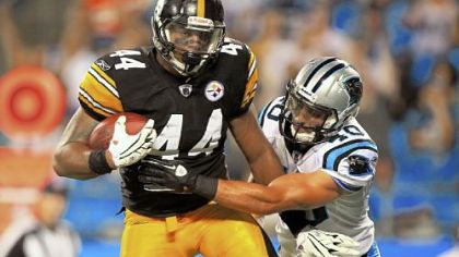 Weslye Saunders catches a touchdown pass during a preseason game in September against the Carolina Panthers' Michael Greco in Charlotte, N.C.