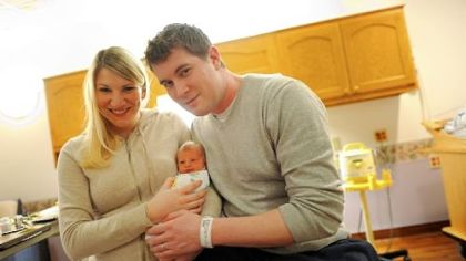 Parents Matthew and Kary Grotkowski hold their newborn son James Jerome, or J.J., Monday at St. Clair Hospital in Mt. Lebanon. J.J. was the first baby born at St. Clair in the new year, arriving at 4:48 a.m. Jan. 1.