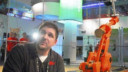 Hoops, the basketball-shooting robot at the Carnegie Science Center, needs a tuneup. The robot's accuracy fell off as mechanical joints wore down after thousands of hours of shooting.
