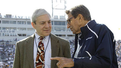 In this  Oct. 8, 2011 file photo, Penn State President Graham Spanier, left, and head football coach Joe Paterno talk before a game against Iowa,  in State College, Pa.