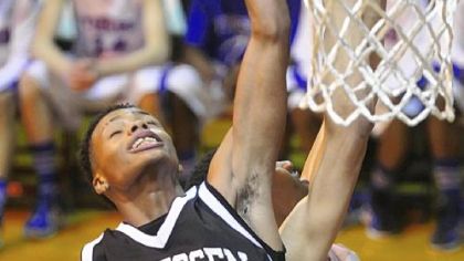 Monessen's Jaisen Irwin battles Wilkinsburg's Jordan Howard for a rebound.