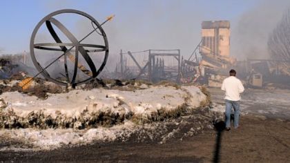 Serguei Velidtchenko, of Markleysburg, Fayette County, walks Monday around a sundial that he built near the fire-leveled ski lodge at Nemacolin Woodlands Resort. Fire that broke out Sunday evening at the lodge continued smouldering Monday. The building was vacant and no one was hurt in the blaze. Officials at the resort say they have made alternate plans for the upcoming Presidents Day weekend and the slopes will be open as usual.