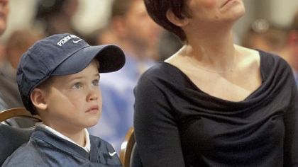 Colleen O'Brien, right, wife of Bill O'Brien and their son Michael, 6, look on as their husband and father began his career as coach at Penn State Saturday in a news conference at the Nittany Lion Inn in University Park.