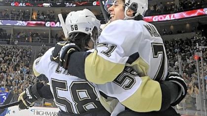 Evgeni Malkin celebrates his tying goal with 6.6 seconds remaining Tuesday night at Consol Energy Center. Joining him is Kris Letang as the Penguins rallied and eventually defeated Toronto in a shootout, 5-4.