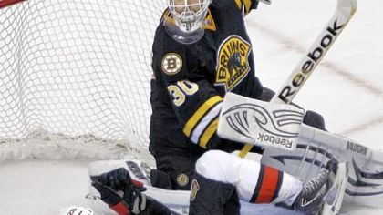 Ottawa's Zenon Konopka crashes to the ice in front of Bruins goalie Tim Thomas Tuesday in Boston. The Bruins rallied for a 4-3 victory.