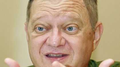 Tom Clancy (shown in a 2004 photo) once again accurately describes military weapons and logistics in his latest book.