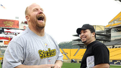 The Steelers' Chris Hoke, jokes with Axy Ruiz of Erie, with his step-son Jonnathon Ulrich, 7, in the background at the Heroes At Heinz Field in 2008. Ruiz, was an Army MP, a Spec. E-4, who served in Iraq in 2004.  The Steelers and VA Healthcare-VISN 4 brought about 7 players and over 100 veterans of Operation Enduring Freedom and Operation Iraqi Freedom and their families together for skill events on the field and a dinner.