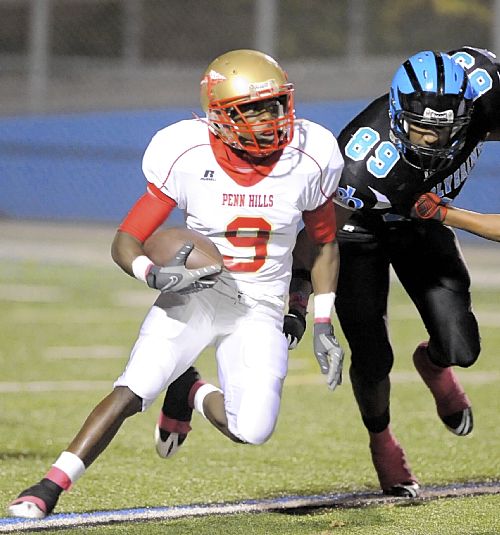 Penn Hills High School's Corey Jones runs for extra yardage against ...