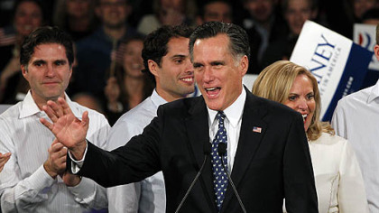Former Massachusetts Gov. Mitt Romney waves to supporters at the "Romney for President" New Hampshire primary night rally at Southern New Hampshire University in Manchester, N.H. Behind him are his sons, Tagg and Craig, and his wife, Ann.