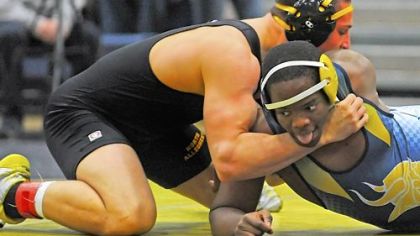 North Allegheny High School's Jarred Lux, left, works to pin Central Catholic's Stuart Hall in the 220-pound weight class in the first round of the WPIAL team tournament at Kiski Area High School.