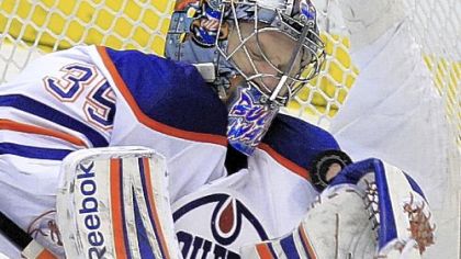 Edmonton Oilers goalie Nikolai Khabibulin deflects a puck in the second period Wednesday night against the Detroit Red Wings at Joe Louis Arena.