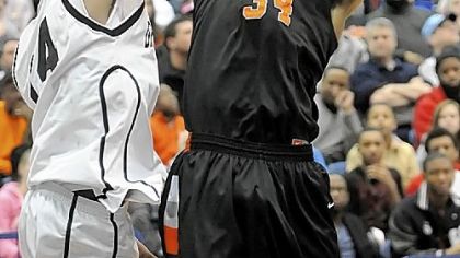 Beaver Falls' Sheldon Jeter grabs a rebound against Monessen's Jaisen Irwin in the WPIAL Class AA championship game Saturday at the Palumbo Center. The Tigers won, 46-27. Jeter is being recruited by Wisconsin, Kansas State, Seton Hall and Penn State.