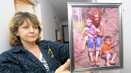 Belinda Aquino holds a photo taken in 2010 of her daughter, Brittany, 23, who died in a fire in 2011. In that picture, Brittany is holding her children -- Ms. Aquino's grandchildren -- Gracie and Renny, who now live with their grandmother in O'Hara.