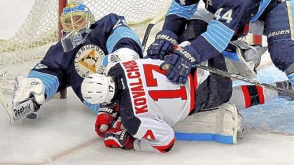 New Jersey's Ilya Kovalchuk gets sandwiched between defenseman Brooks Orpik and goalie Marc-Andre Fleury Saturday.