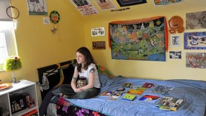 Marissa Veldman with her sister Kelsey's remains and several pieces of art done by her sister at the Veldmans' home in Shaler. Marissa was addicted to heroin and her sister died of an overdose the first time she did heroin.