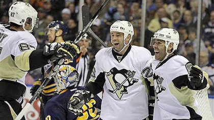 The Penguins' Steve Sullivan celebrates his goal with teammates Sidney Crosby and Pascal Dupuis on Buffalo Sabres goalie Ryan Miller during the second period of tonight's game in Buffalo, N.Y.