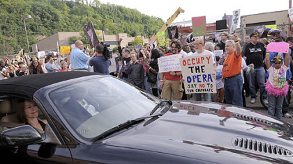 Protesters gather outside the Pittsburgh Opera building in the Strip District to denounce Governor Tom Corbett, who received a lifetime achievement award from the opera.
