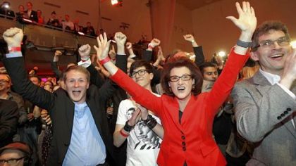 Social Democratic Party members react happily Sunday to the first results published in Duesseldorf, Germany.