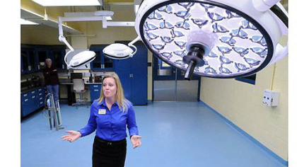 Ginger Takle, director of animal health, describes the treatment room during a tour of the new Animal Care Center at the zoo.
