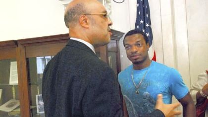 Jordan Miles, right, who was beaten by three Pittsburgh police officers, talks with city Councilman Ricky Burgess in 2011.