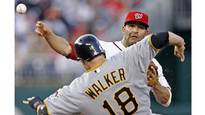 Washington Nationals second baseman Danny Espinosa throws over Pirates' Neil Walker  to connect for the double play on a ball hit by Andrew McCutchen.