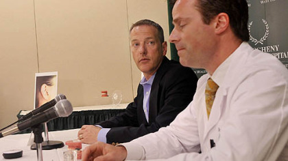 Paul Getsy, of Plum, one of the patients at Allegheny General Hospital using the SoundBite hearing system, listens Tuesday to Dr. Todd Hillman describe the unit, which uses bone conduction to transmit sound vibrations picked up by a small microphone placed in the ear.