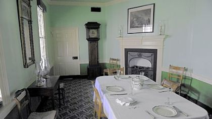 Christopher Cowan bought Woodville Plantation (aka Neville House) in what is now Collier in 1814. Cowan did extensive additions and renovations, which included connecting the outbuilding that housed the kitchen to the main structure. The connecting portion became the dining room, which still has Cowan's grandfather clock in it.