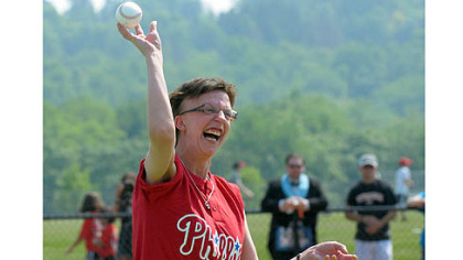 Genny Kanka throws out the first pitch at the first game Saturday on the newly opened Miracle League Field in Boyce Mayview Park in Upper St. Clair.