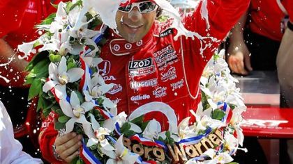 Dario Franchitti celebrates with the traditional jug of milk after winning the 96th Indianapolis 500.