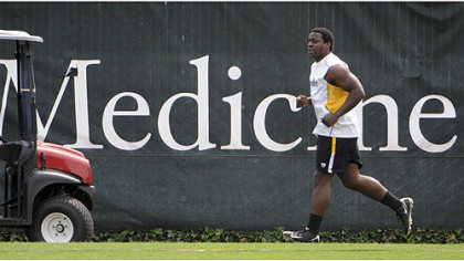 Running back Rashard Mendenhall jogs along the perimeter of the practice field as he continues to rehab from knee surgery.