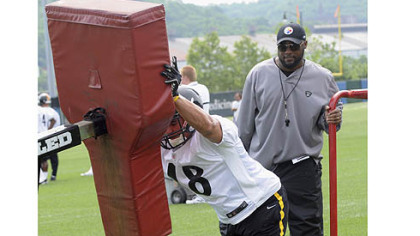 Head coach Mike Tomlin watches rookie tight end David Paulson in a blocking drill.