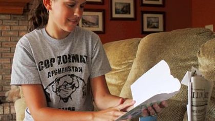 Cami Abernethy, 22, reads one of many get-well cards.