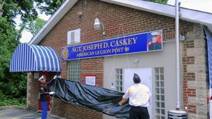 A new sign outside American Legion Post 80 in Ross is unveiled during the dedication ceremony of Sgt. Joseph D. Caskey American Legion Post 80, adopting the name of a local fallen marine.