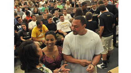 Steelers quarterback Charlie Batch and Latasha Wilson-Batch, center, talk with Candi Castleberry-Singleton, founder of the Dignity and Respect Campaign before an event at Brentwood High School to deal with an incident at a Brentwood-Monessen sporting event. The assembly, held in the Brentwood auditorium, included participants from Monessen.