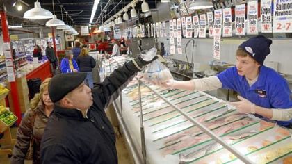 Rob Warywoda sells fish at Wholey's in the Strip District. His customer is Ed Lancia of Beechview.