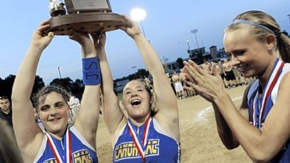 Canon-McMillan's Giorgiana Zeremenko and Alayna Astuto hold up the trophy after defeating Hempfield in the WPIAL Class AAAA championship Thursday at California University.