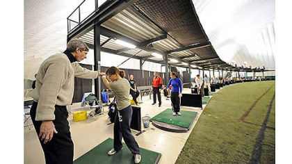 In this 2008 photo, instructor Jim Cichra (left) gives a golf lesson to Kendall Allen in the Golf Dome at Robert Morris University's Island Sports Center on Neville Island.