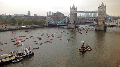 An armada of more than a thousand skiffs, dhows, tugboats and other motorcraft move down the Thames under London Bridge in a flotilla celebrating Queen Elizabeth II's Diamond Jubilee.