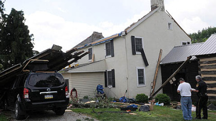 Public safety officials from Westmoreland County survey damage to the home of Steve and Tracey Pelesky in Ligonier on Saturday after a suspected tornado hit the area Friday.