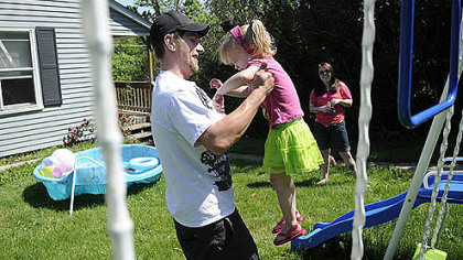 Jason Stiffler picks up his daughter, Holland Starr Stiffler, 2, while her mother, Rachel Bellaire, watches at their home Wednesday in North Fayette.